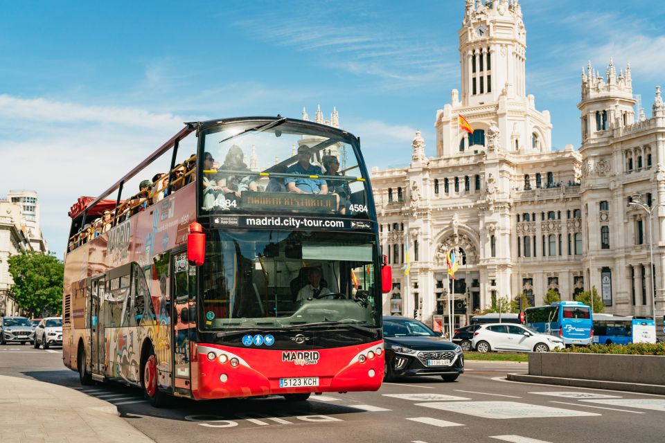 madrid-hop-on-hop-off-bus-blog-post-cover a double decker bus driving down a street