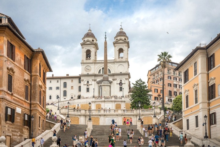 a group of people walking in front of Spanish Steps