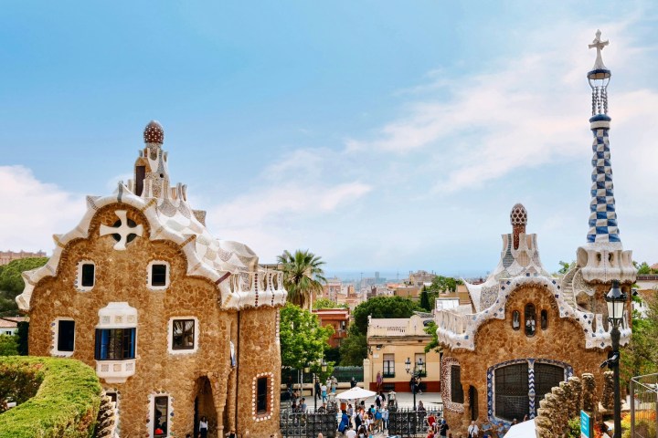 a group of people walking in front of Park Güell