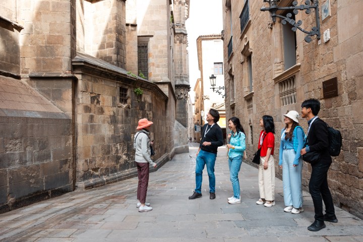 a group of people walking on a sidewalk