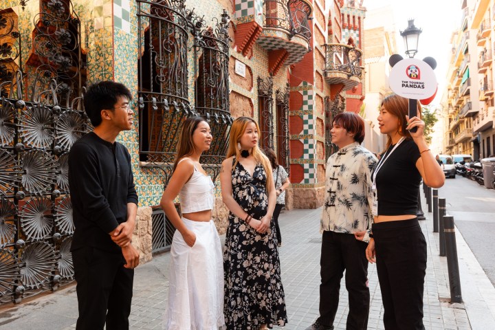 a group of people standing on a sidewalk
