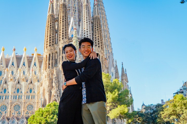 a person standing in front of a tall building