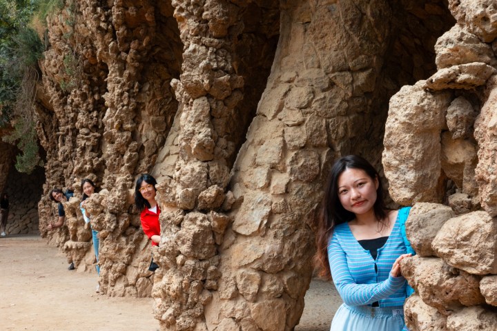 a person holding a teddy bear on a rock