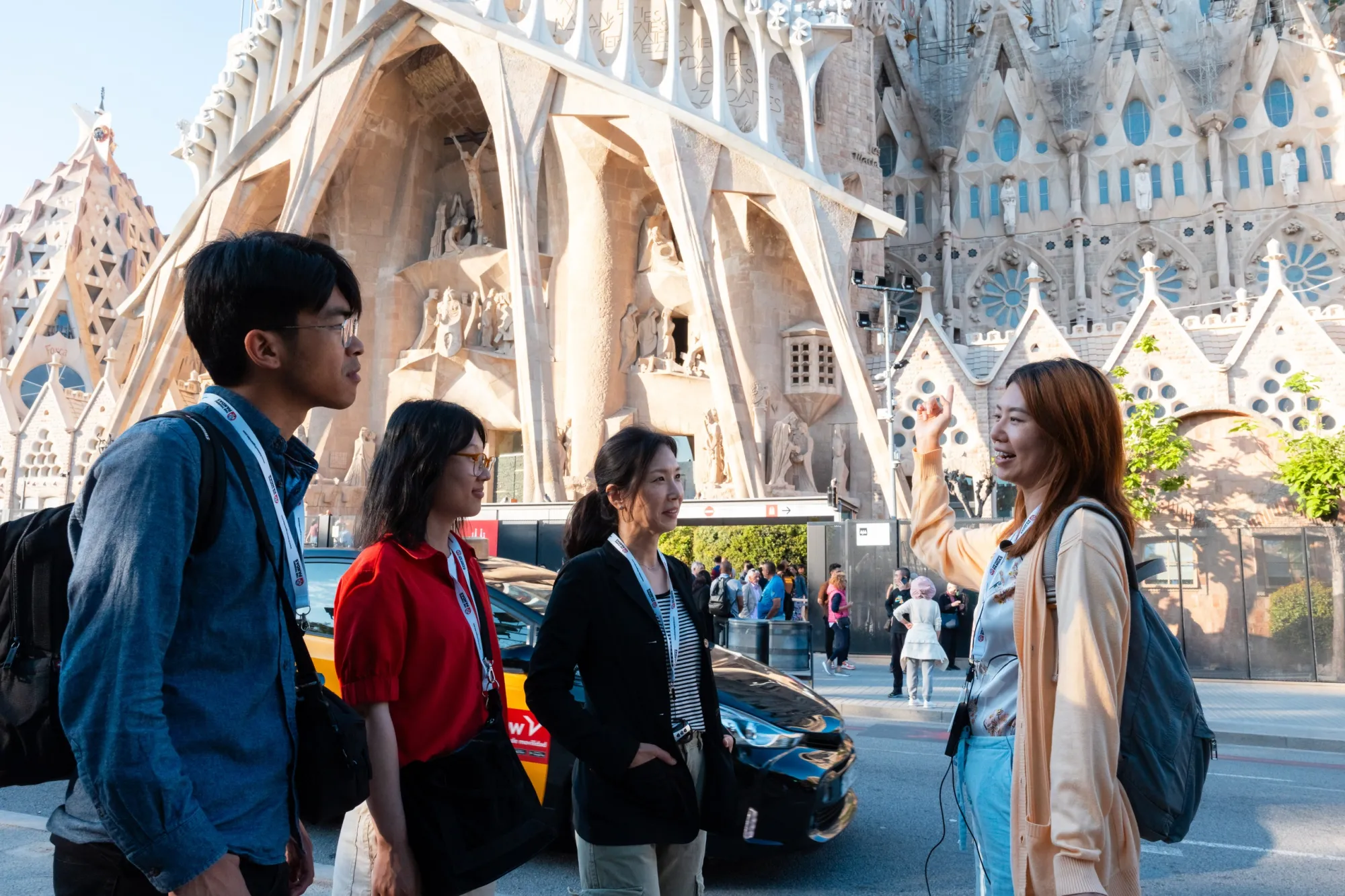 a group of people standing in front of the passion facade of sagrada familia