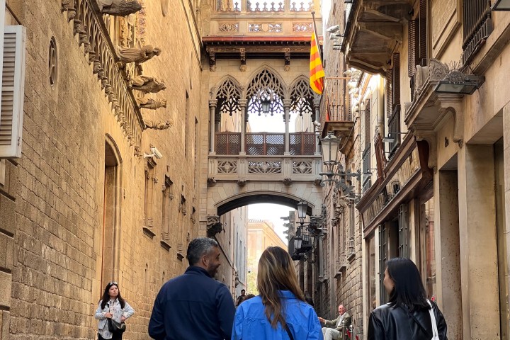 a group of people walking down a street in front of a building