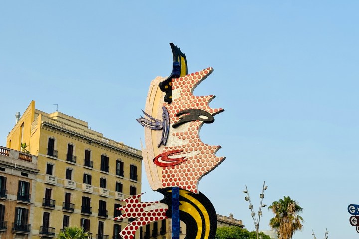 a group of people flying kites in a building