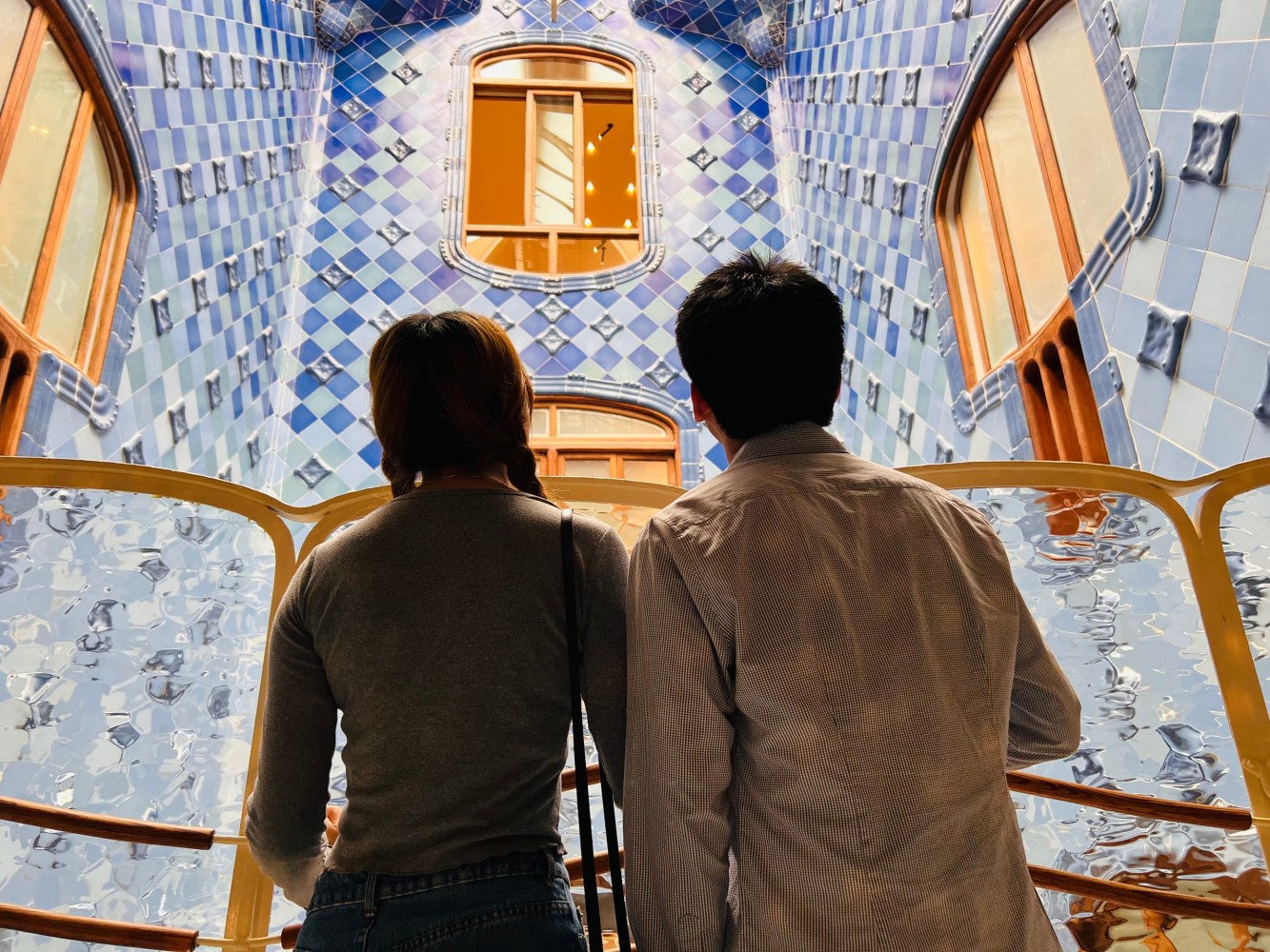 a man and a woman standing in front of a wall