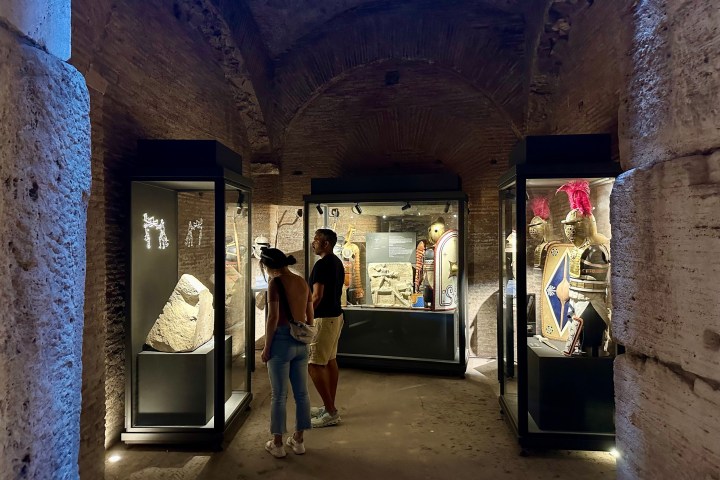 a group of people standing in front of a brick building