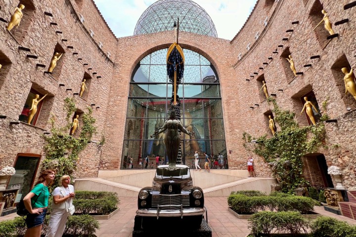 a large stone statue in front of a building