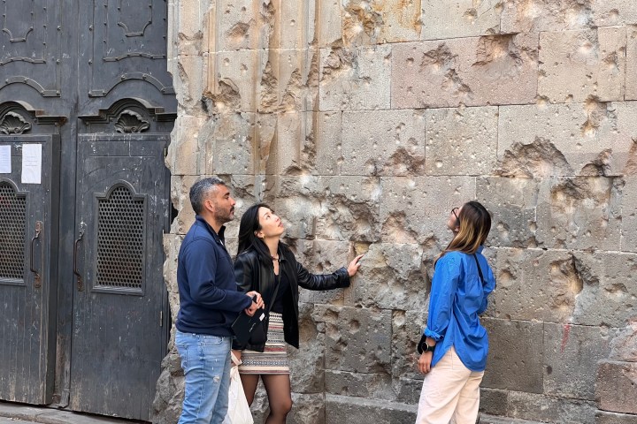 a group of visitors standing in front of a church in Barcelona's Gothic Quarter