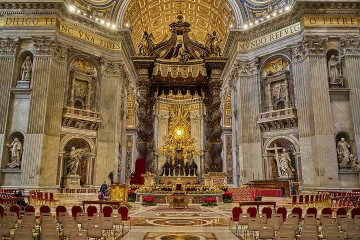 a group of people in front of a church with St. Peter's Basilica in the background