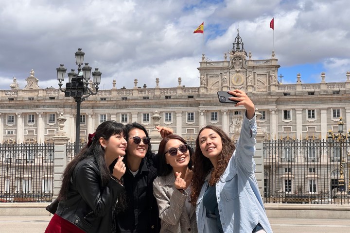 a group of people posing in front of a building