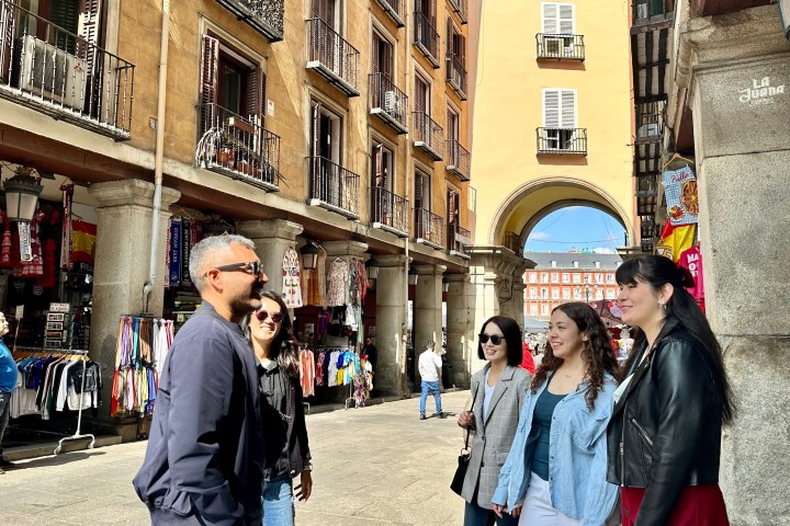 a group of people walking on a city street