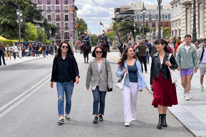 a group of people walking on a city street