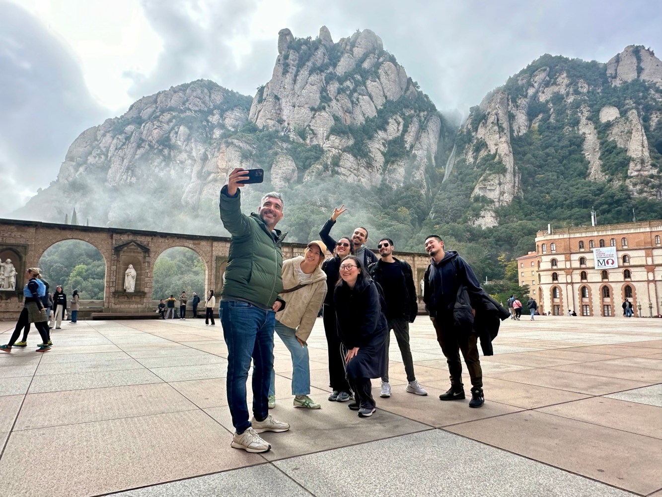 a group of people walking in front of a mountain