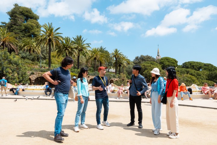 a group of people standing in a parking lot