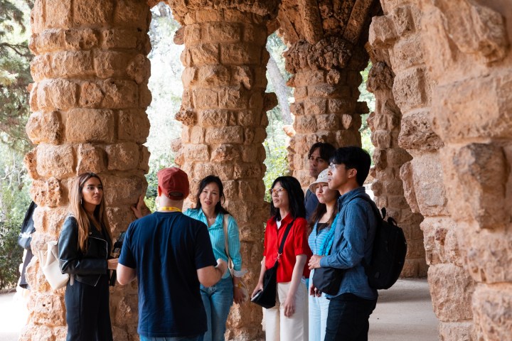 a group of people standing in front of a brick wall
