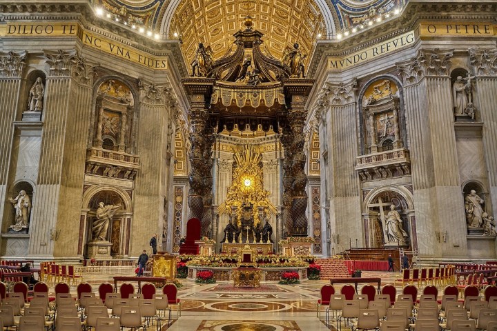 a group of people in front of a church with St. Peter's Basilica in the background