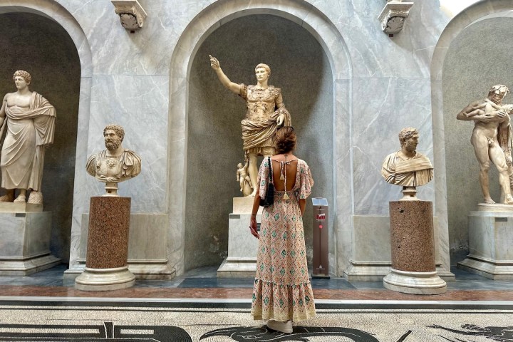 a large stone statue in front of a building