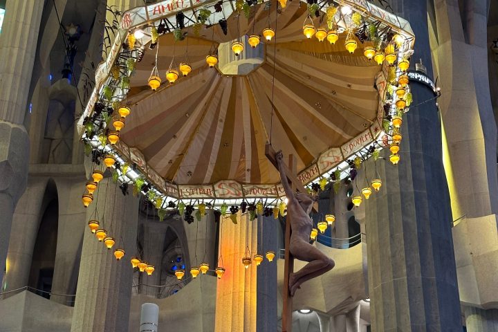 a group of people performing on stage in front of a building