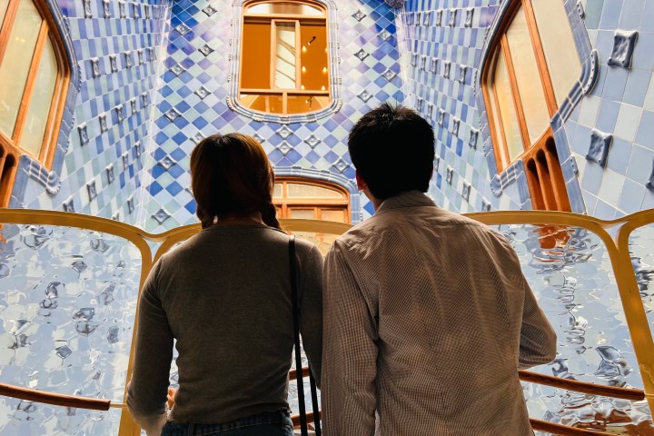 a man and a woman standing in front of a wall