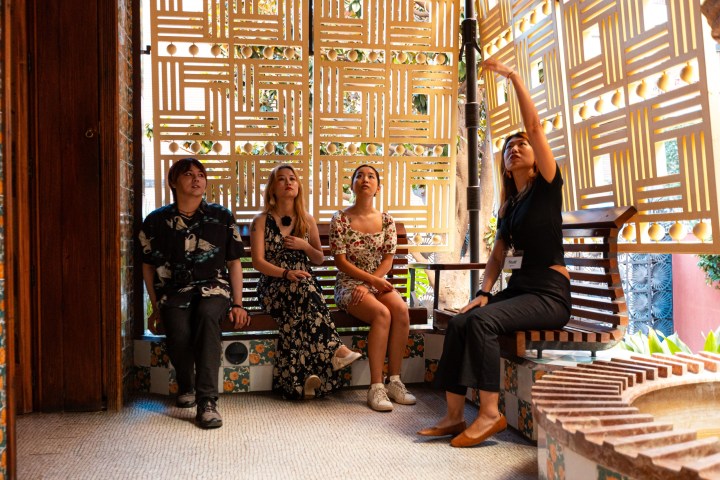 a group of people sitting on a bench in front of a building