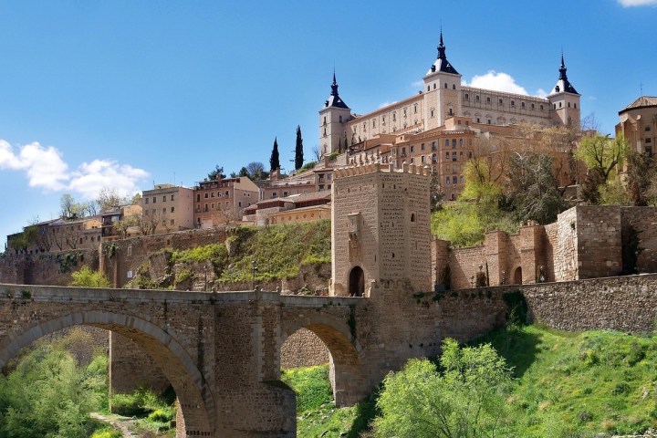 a stone castle next to a bridge