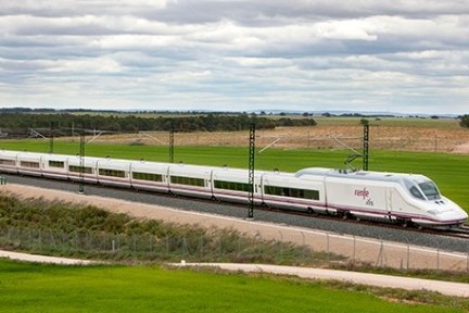 a train traveling down train tracks near a field