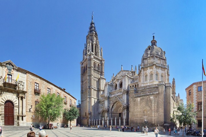 a group of people walking in front of a church