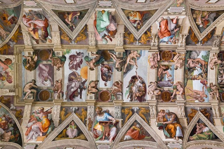 Ceiling of the Sistine Chapel with intricate frescoes and figures.
