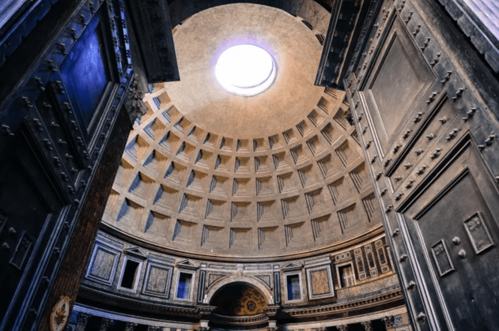 Interior of the Pantheon dome with an open oculus and ornate wall details.