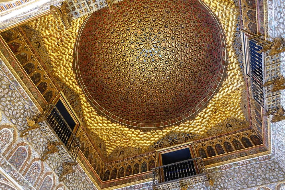Ornate dome ceiling with intricate gold and red geometric patterns and decorative arches.