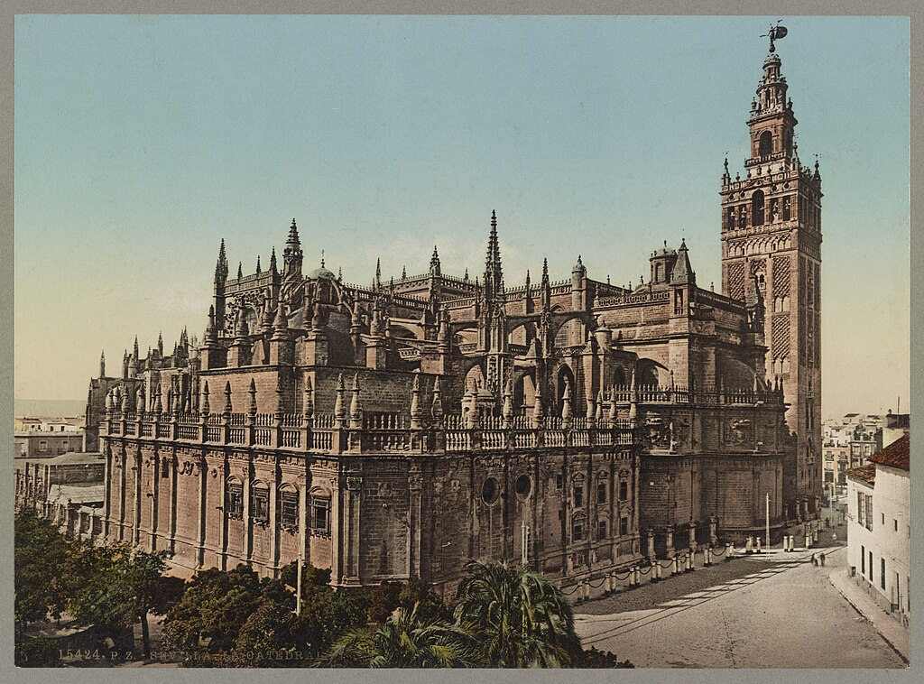A large, ornate Gothic cathedral with a tall bell tower in a city setting.