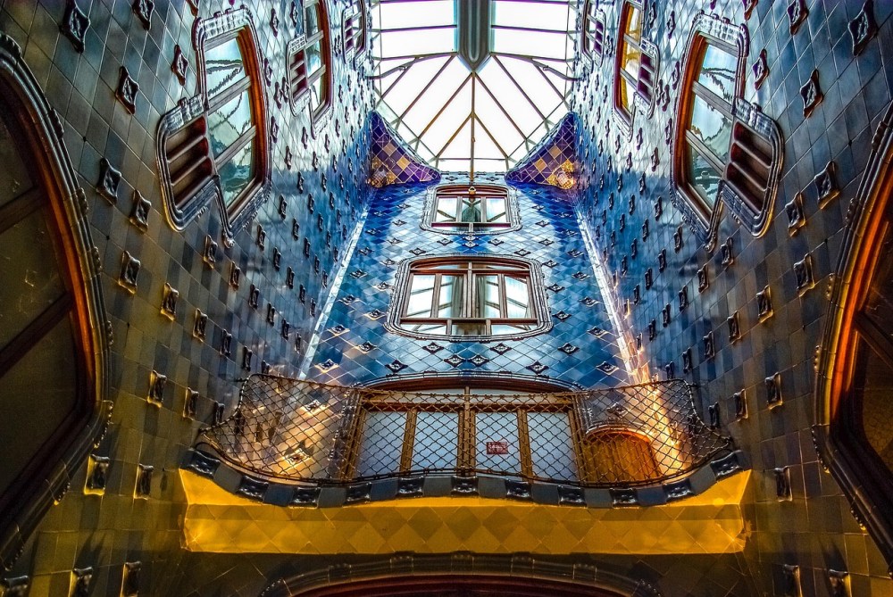 Colorful interior of a building with blue tiles and skylight.