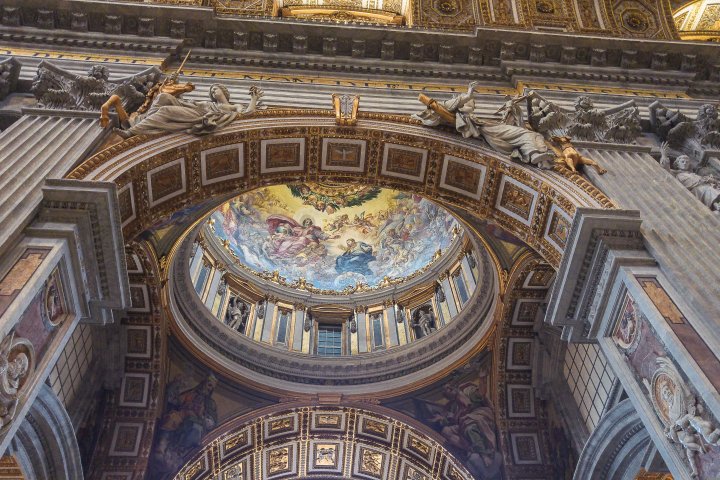 Ornate church interior with detailed frescoes and archways.