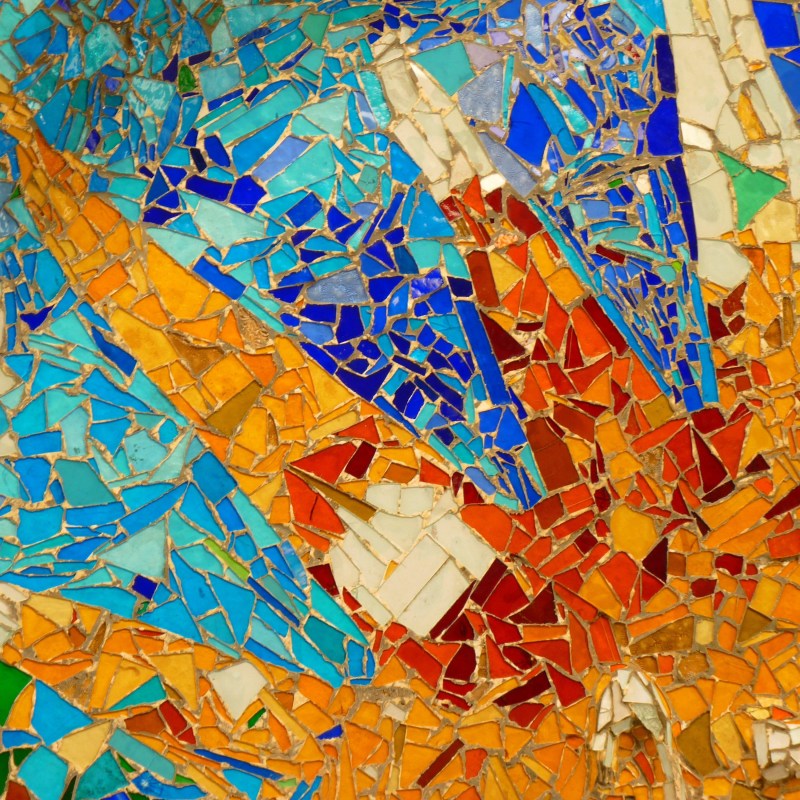Colorful mosaic with orange, blue, and yellow tiles.